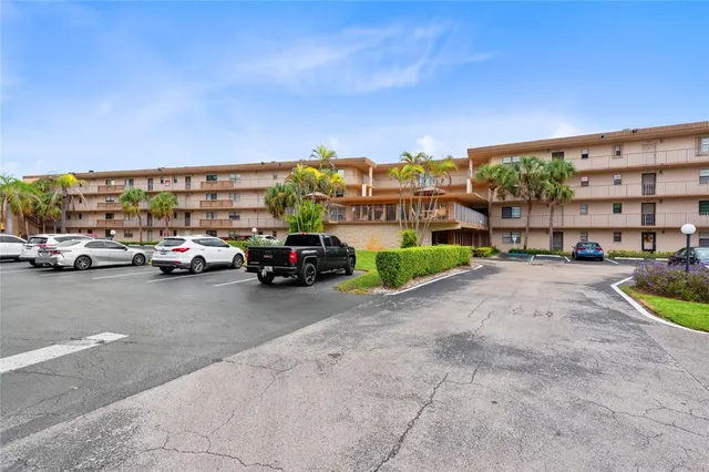 a view of building with cars parked