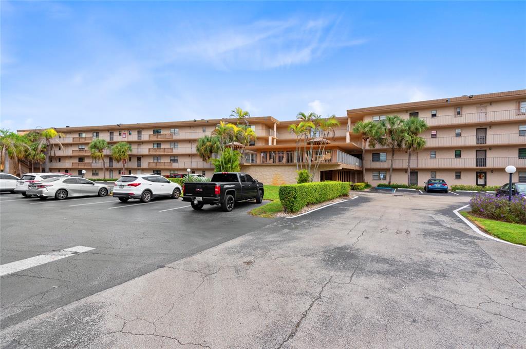 9300 Southwest 8th Street, Unit 102 Boca Raton, FL 33428 - Photo 2 of 23 a view of building with cars parked