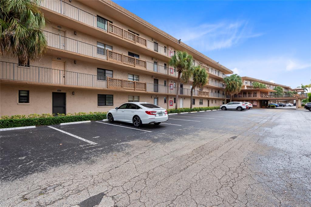 9300 Southwest 8th Street, Unit 102 Boca Raton, FL 33428 - Photo 21 of 23 a car parked in front of a building