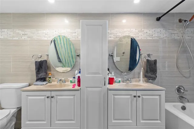 a bathroom with a sink vanity and a mirror