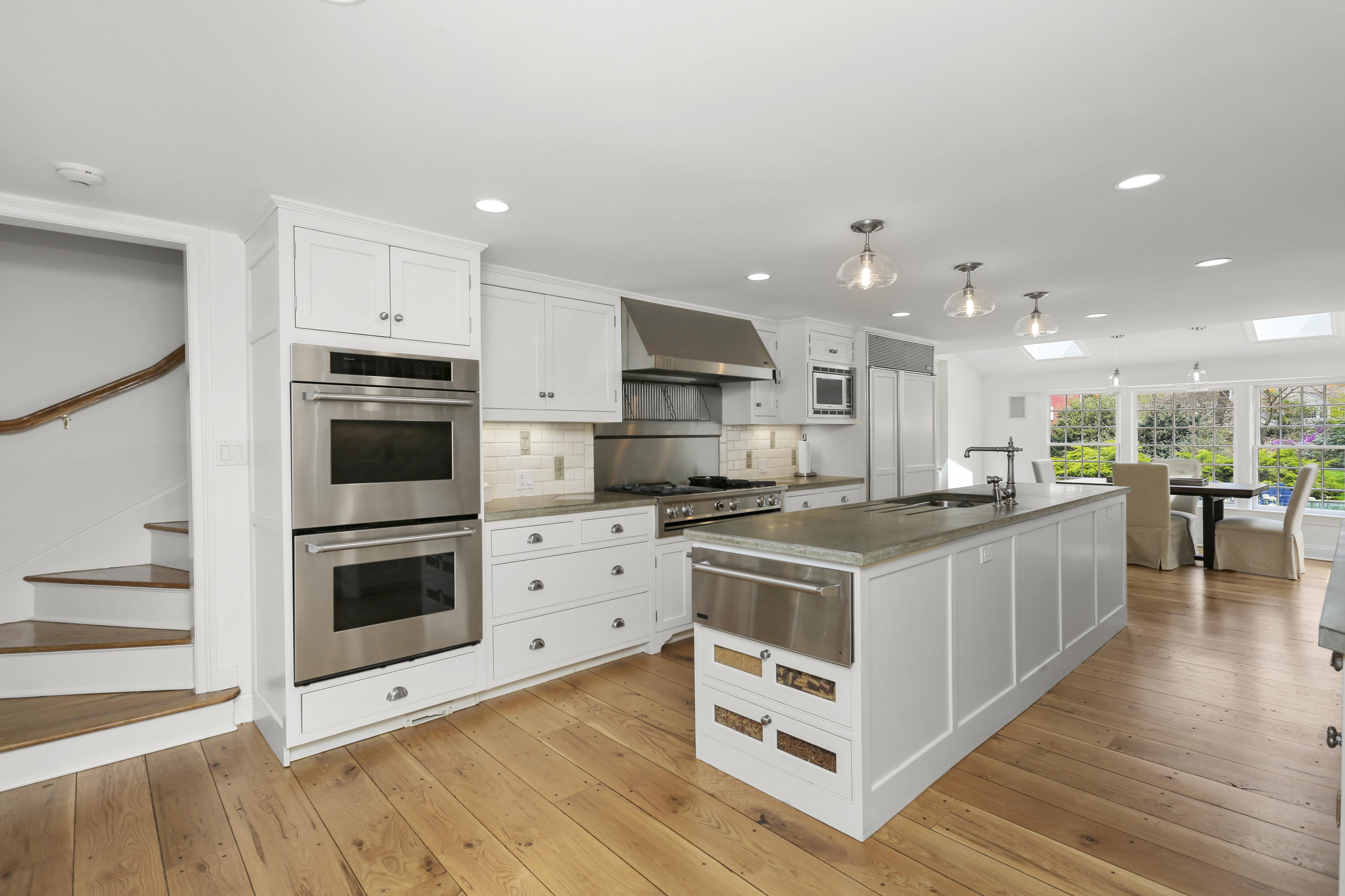 15 Old Farm Road Darien, CT 06820 - Photo 25 of 90 a kitchen with stainless steel appliances kitchen island granite countertop a stove a refrigerator and a microwave oven with white cabinets