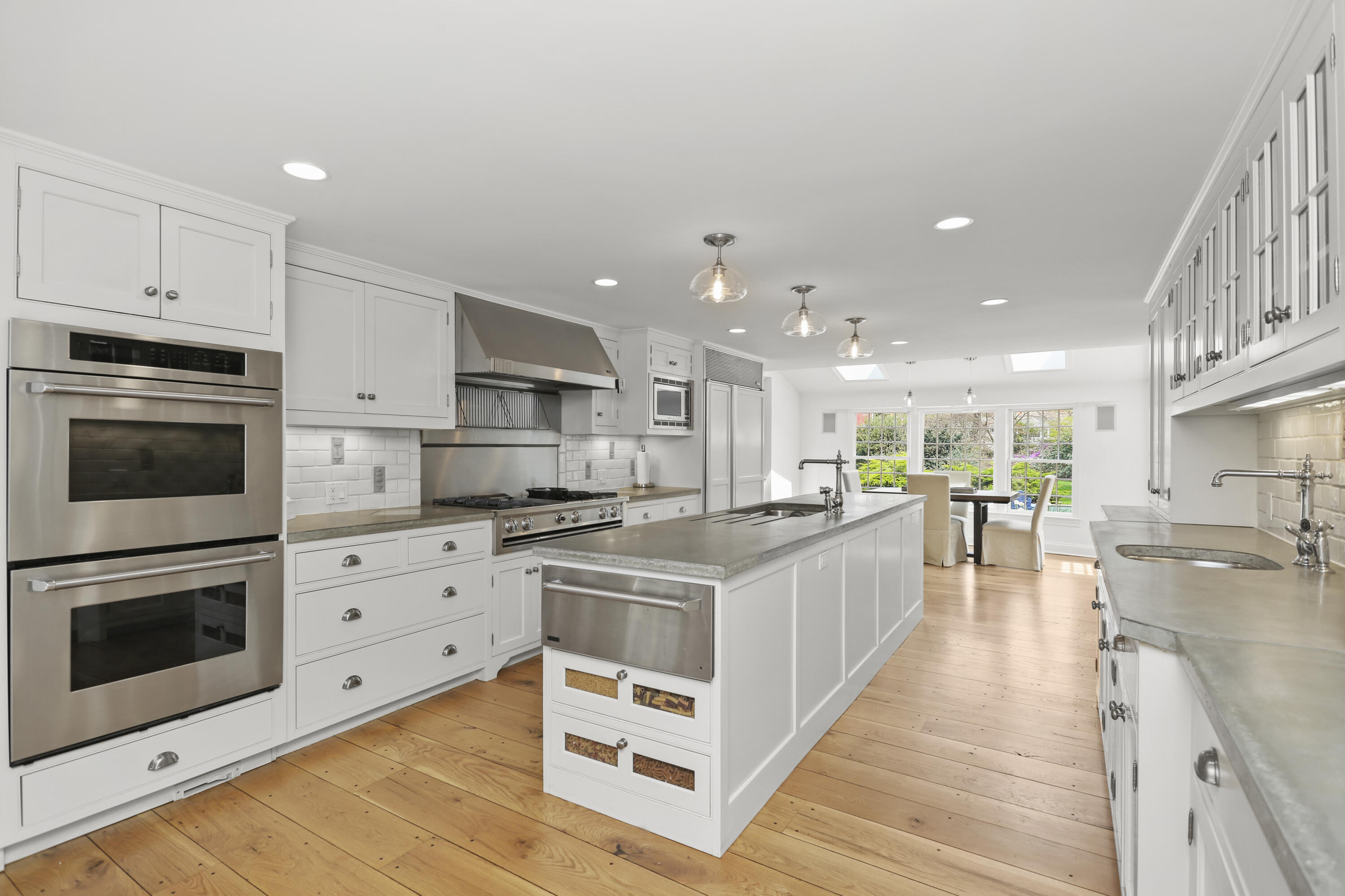 15 Old Farm Road Darien, CT 06820 - Photo 26 of 90 a kitchen with stainless steel appliances kitchen island granite countertop a stove top oven a sink dishwasher and a oven with wooden floor