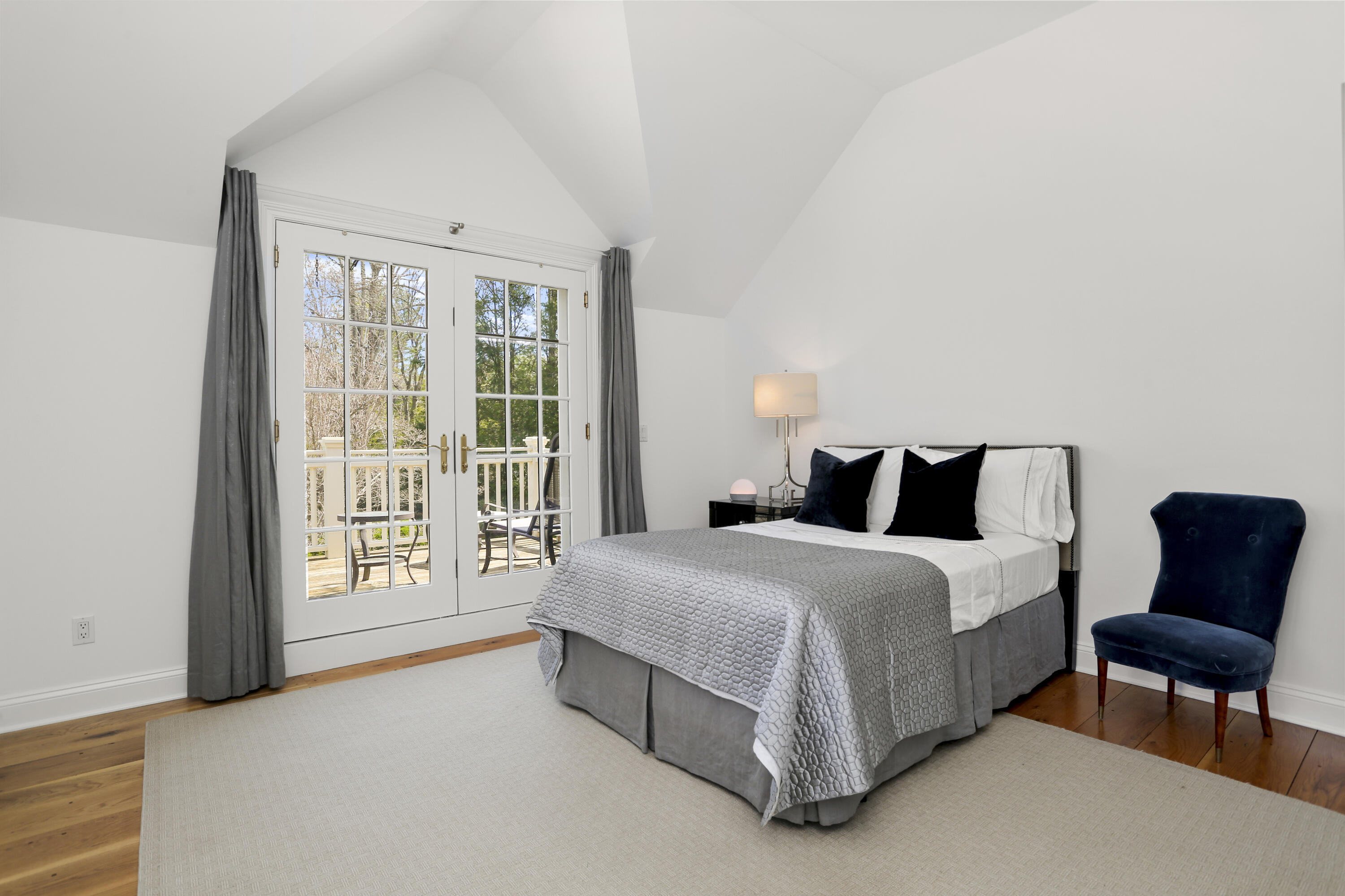 15 Old Farm Road Darien, CT 06820 - Photo 51 of 90 a spacious bedroom with a bed and glass window