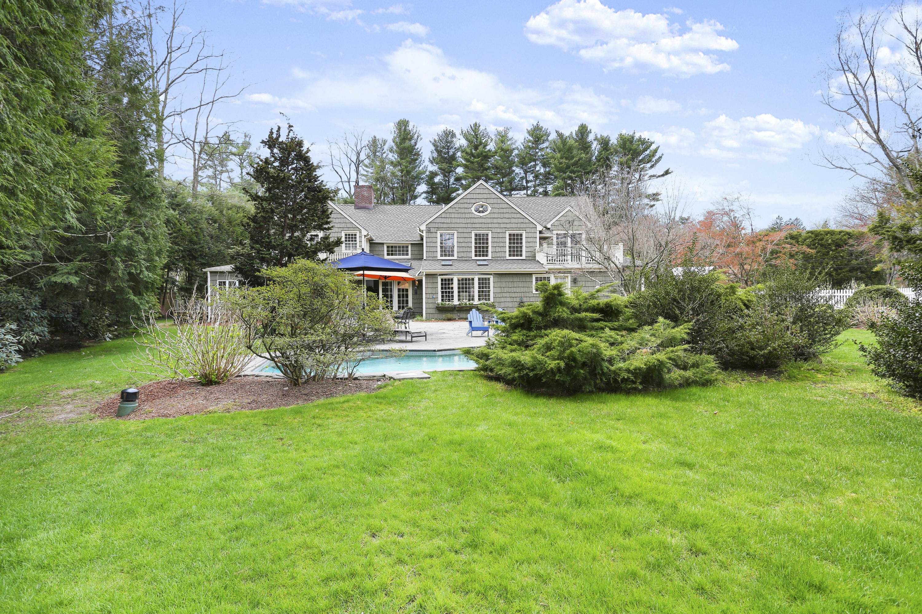 15 Old Farm Road Darien, CT 06820 - Photo 66 of 90 a front view of a house with a yard table and chairs