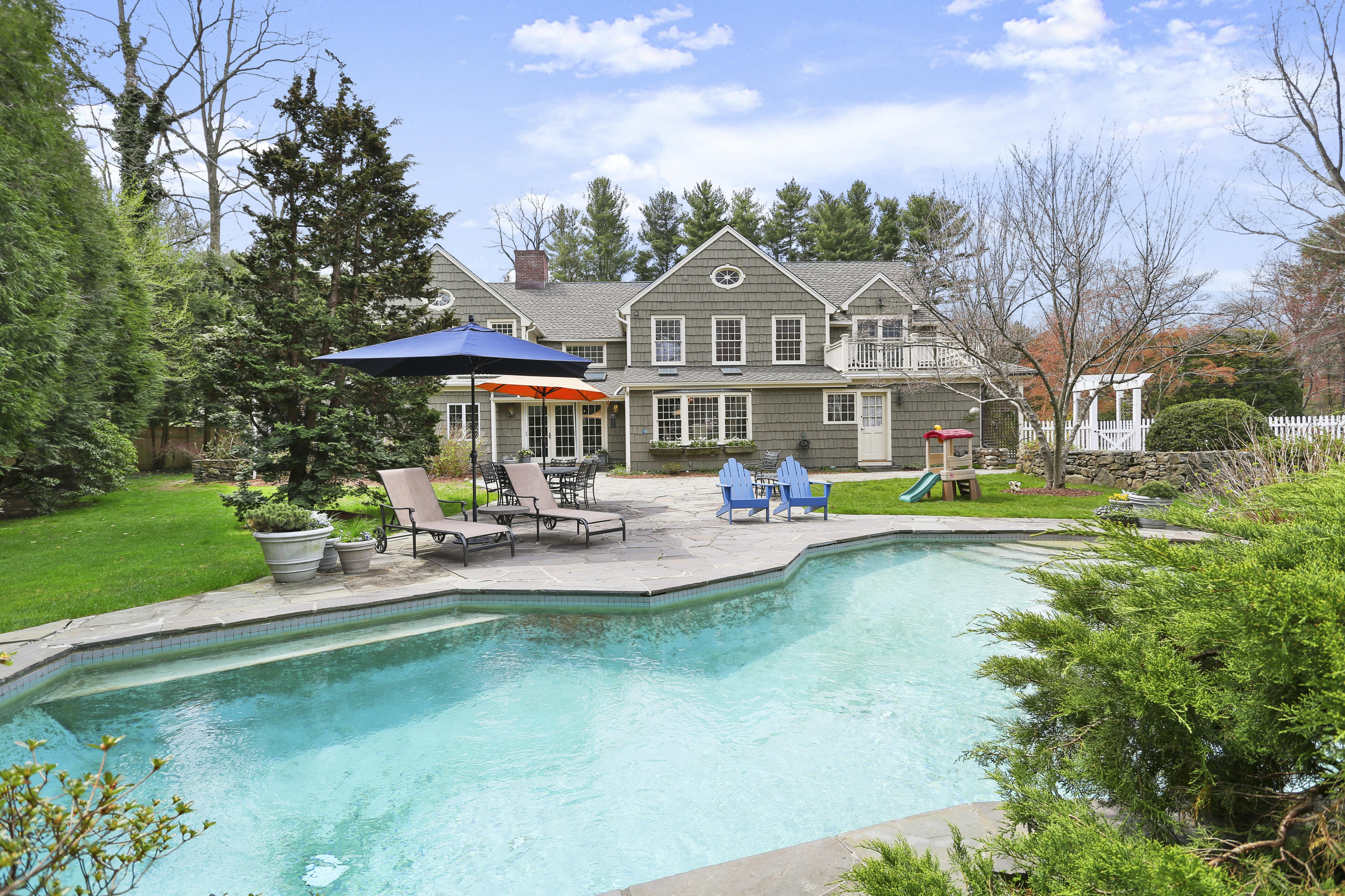 15 Old Farm Road Darien, CT 06820 - Photo 67 of 90 a front view of a house with swimming pool having outdoor seating