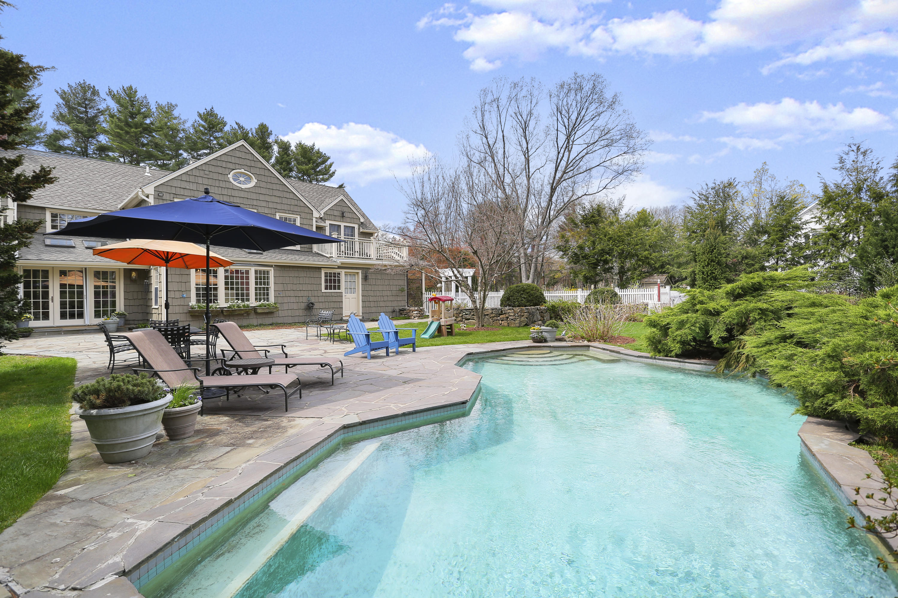 15 Old Farm Road Darien, CT 06820 - Photo 68 of 90 a view of a patio with couches and table and chairs under an umbrella