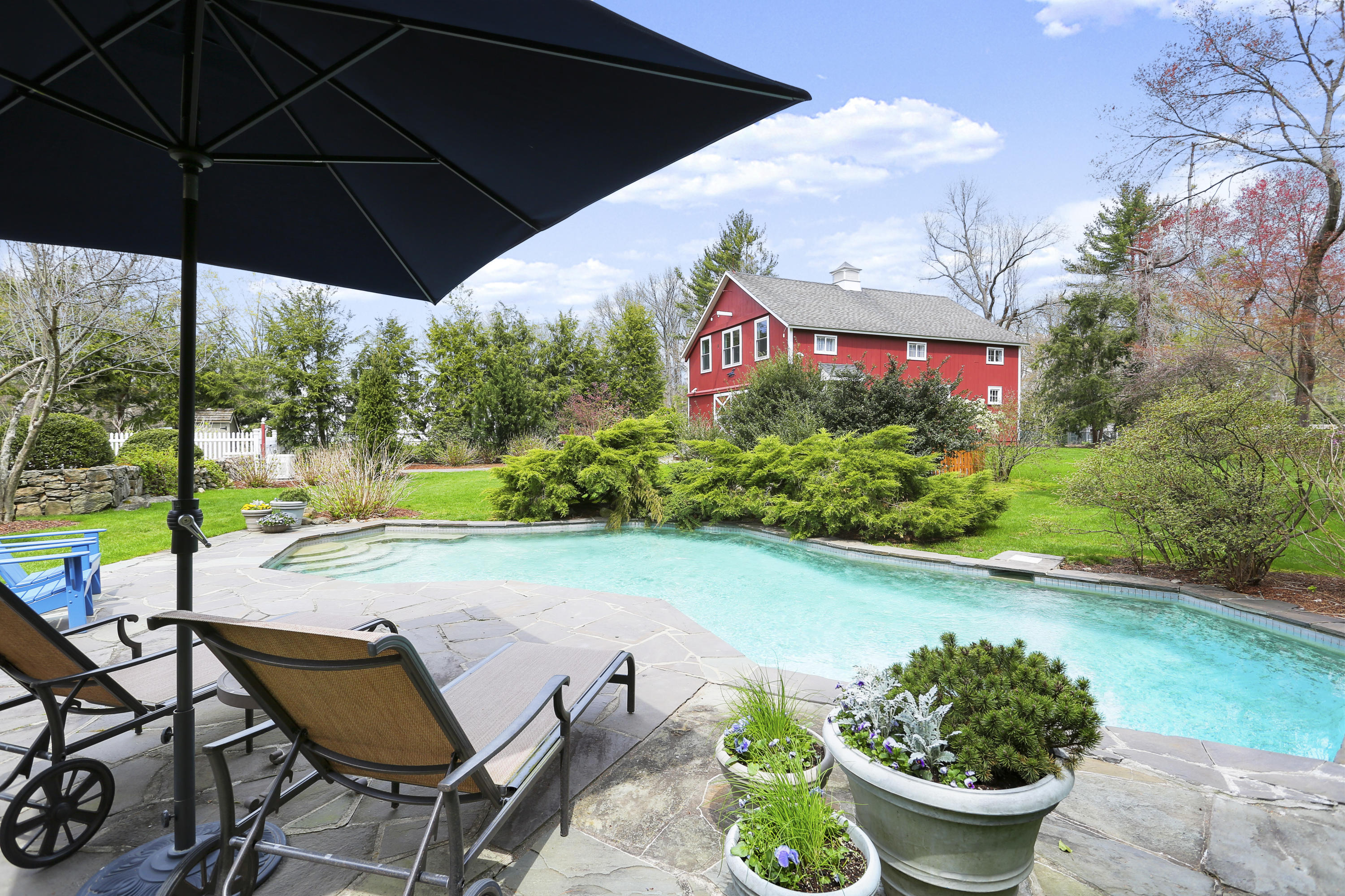 15 Old Farm Road Darien, CT 06820 - Photo 69 of 90 a view of a chairs and table under an umbrella in backyard
