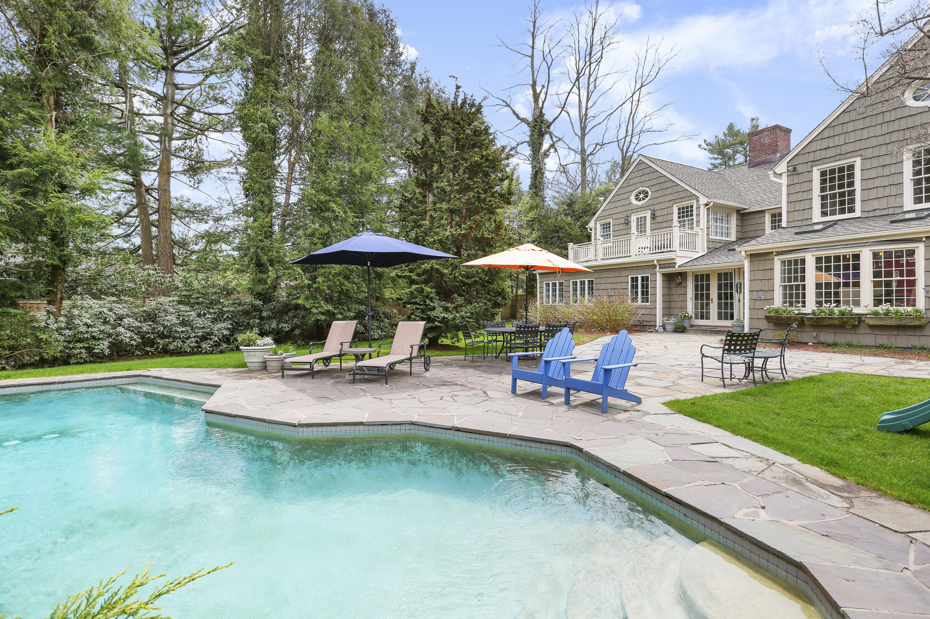 15 Old Farm Road Darien, CT 06820 - Photo 72 of 90 a view of swimming pool with outdoor seating and trees in the background