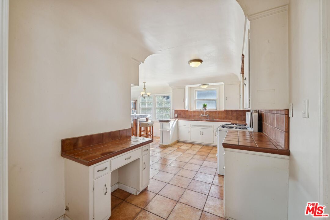 5002 Valley Ridge Avenue View Park, CA 90043 - Photo 15 of 44 a kitchen with a sink cabinets and wooden floor