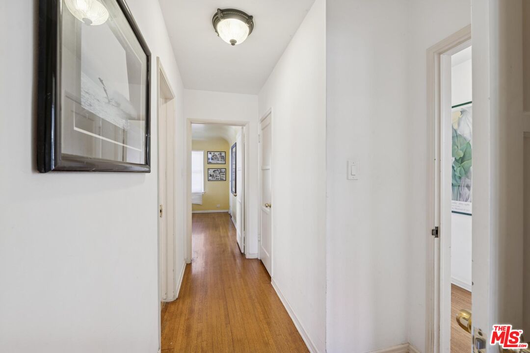 5002 Valley Ridge Avenue View Park, CA 90043 - Photo 18 of 44 a view of a hallway with wooden floor and a bathroom