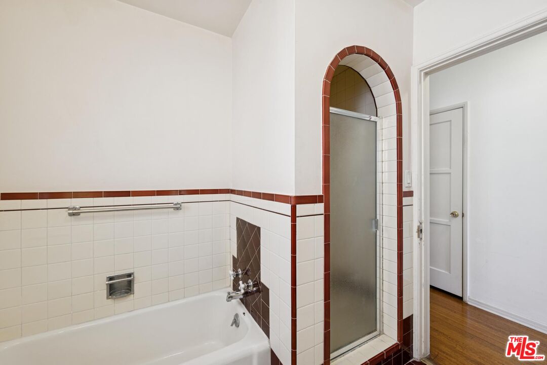 5002 Valley Ridge Avenue View Park, CA 90043 - Photo 21 of 44 a bathroom with a glass door shower and a sink