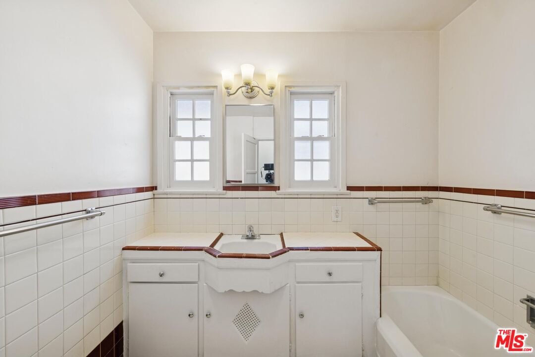 5002 Valley Ridge Avenue View Park, CA 90043 - Photo 22 of 44 a bathroom with a sink and a bathtub