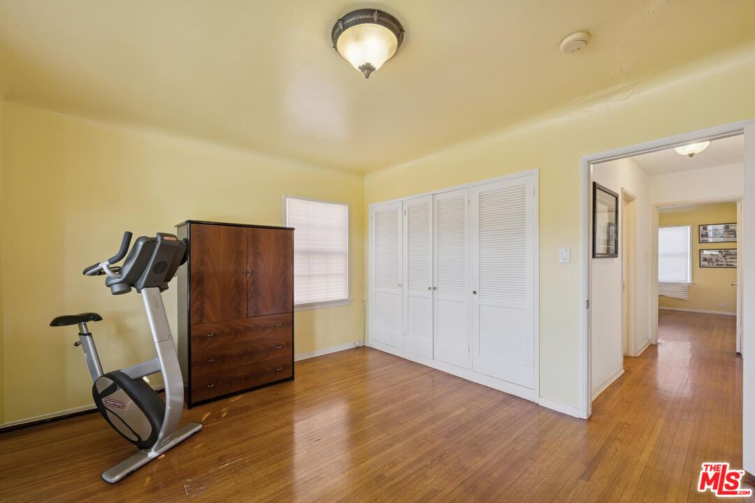 5002 Valley Ridge Avenue View Park, CA 90043 - Photo 23 of 44 a view of a room with wooden floor and windows