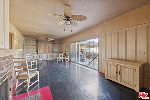 a living room with furniture a fireplace and wooden floor