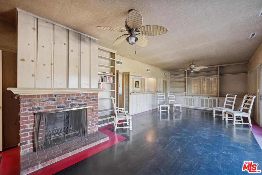5002 Valley Ridge Avenue View Park, CA 90043 - Photo 28 of 44 a living room with furniture a fireplace and wooden floor