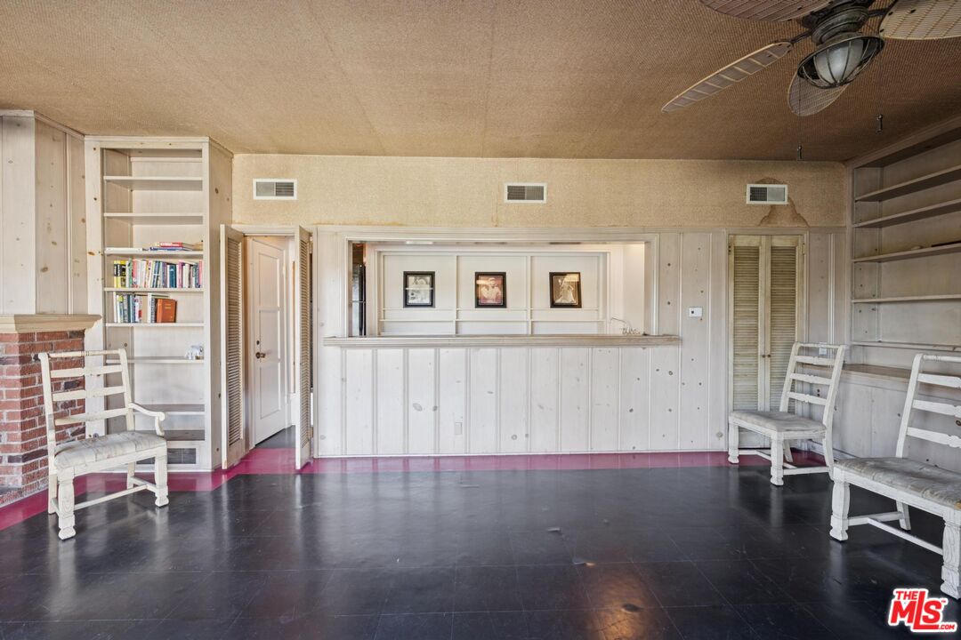 5002 Valley Ridge Avenue View Park, CA 90043 - Photo 29 of 44 a view of an empty room with wooden floor and a window