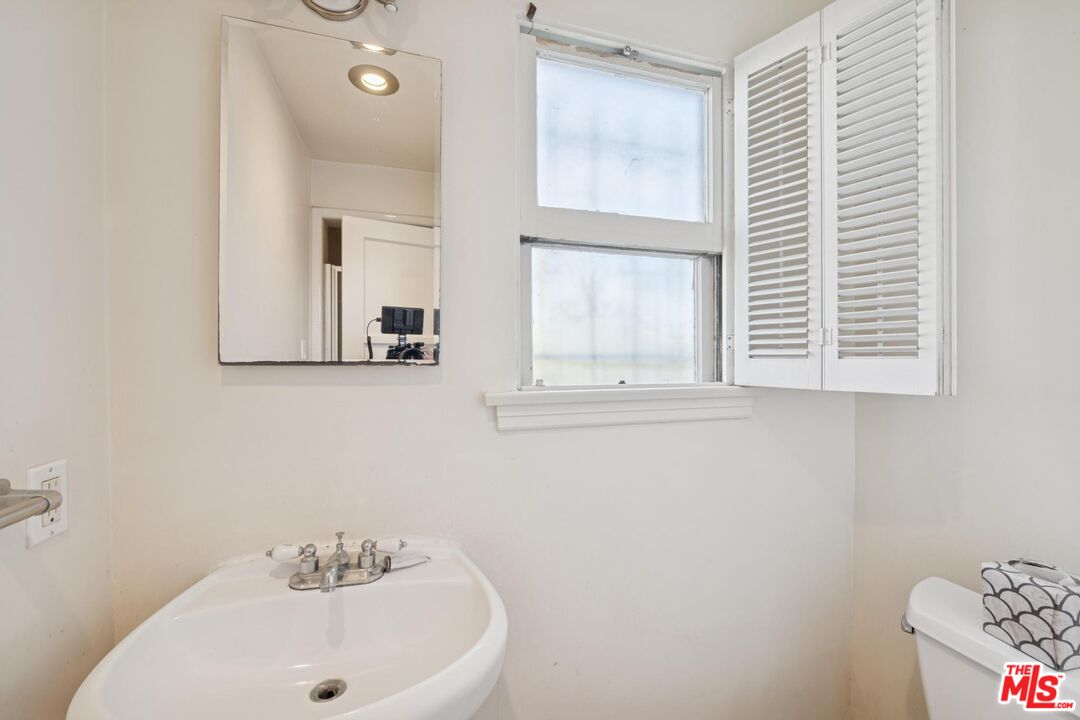 5002 Valley Ridge Avenue View Park, CA 90043 - Photo 32 of 44 a bathroom with a sink and a window