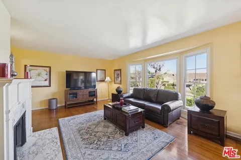 a living room with furniture flat screen tv and a fireplace