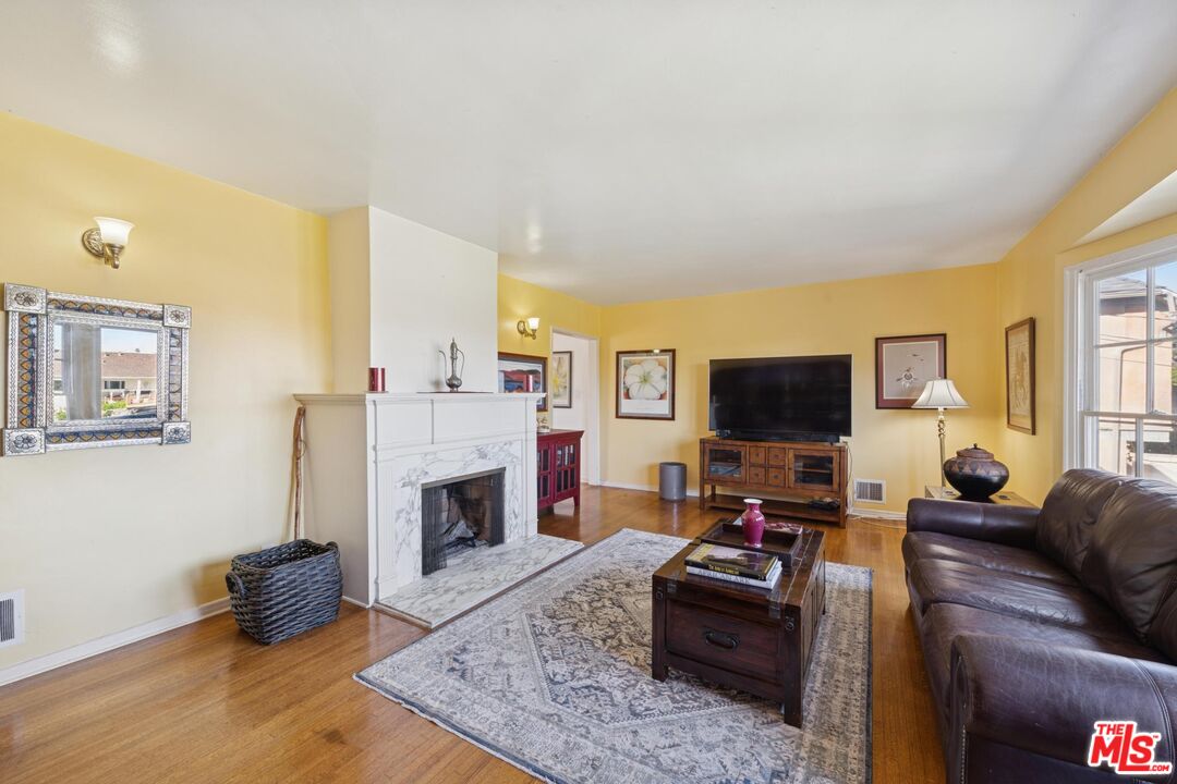 5002 Valley Ridge Avenue View Park, CA 90043 - Photo 8 of 44 a living room with furniture and a fireplace or television