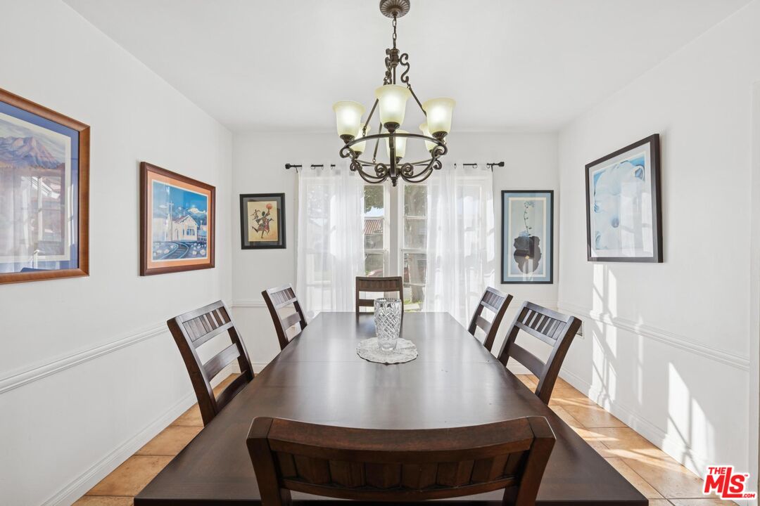 5002 Valley Ridge Avenue View Park, CA 90043 - Photo 10 of 44 a view of a dining room with furniture window and wooden floor