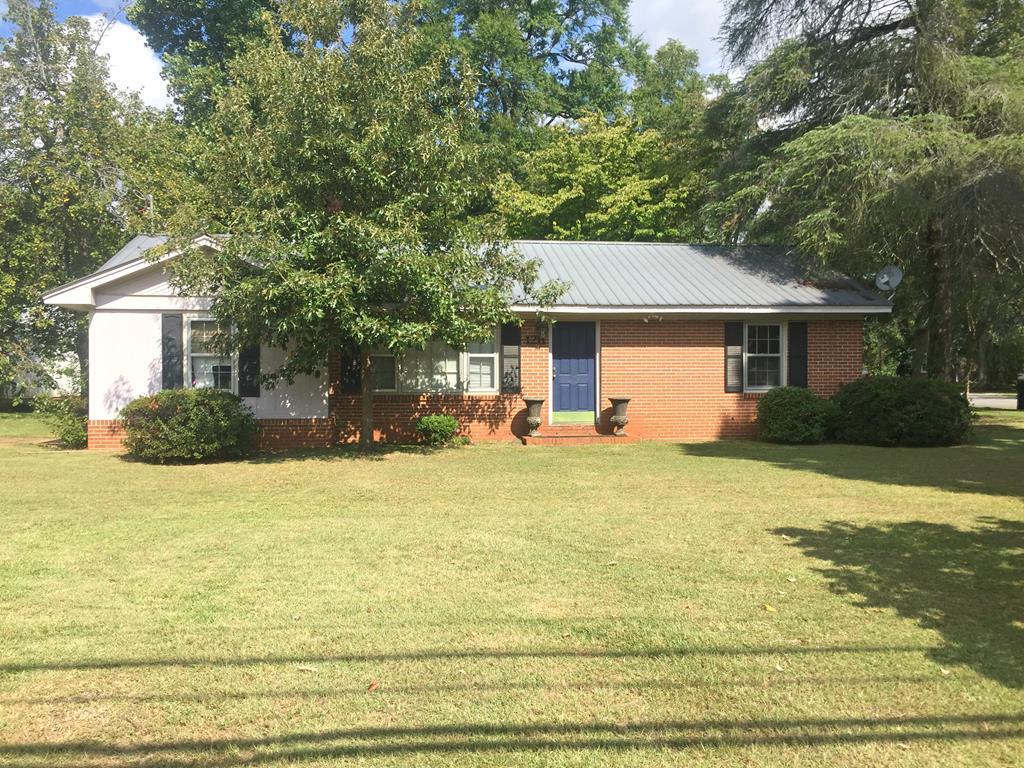 1211 Houston Lake Road Perry, GA 31069 - Photo 1 of 2 a front view of house with yard and trees around