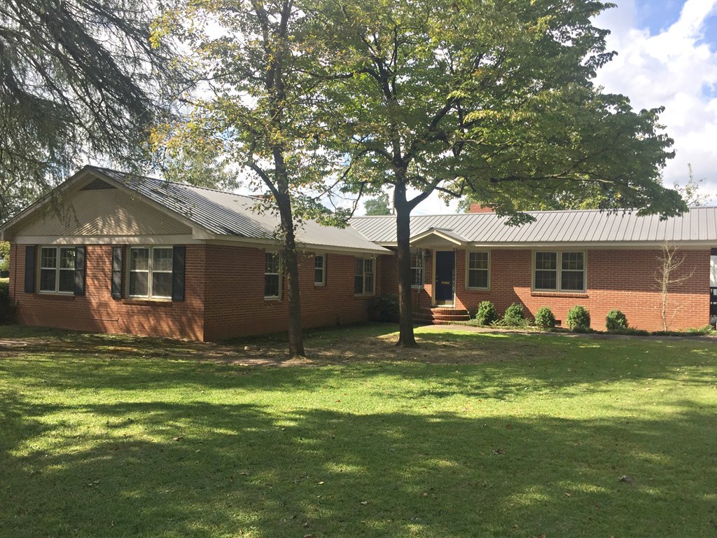 1211 Houston Lake Road Perry, GA 31069 - Photo 2 of 2 a backyard of a house with yard table and chairs
