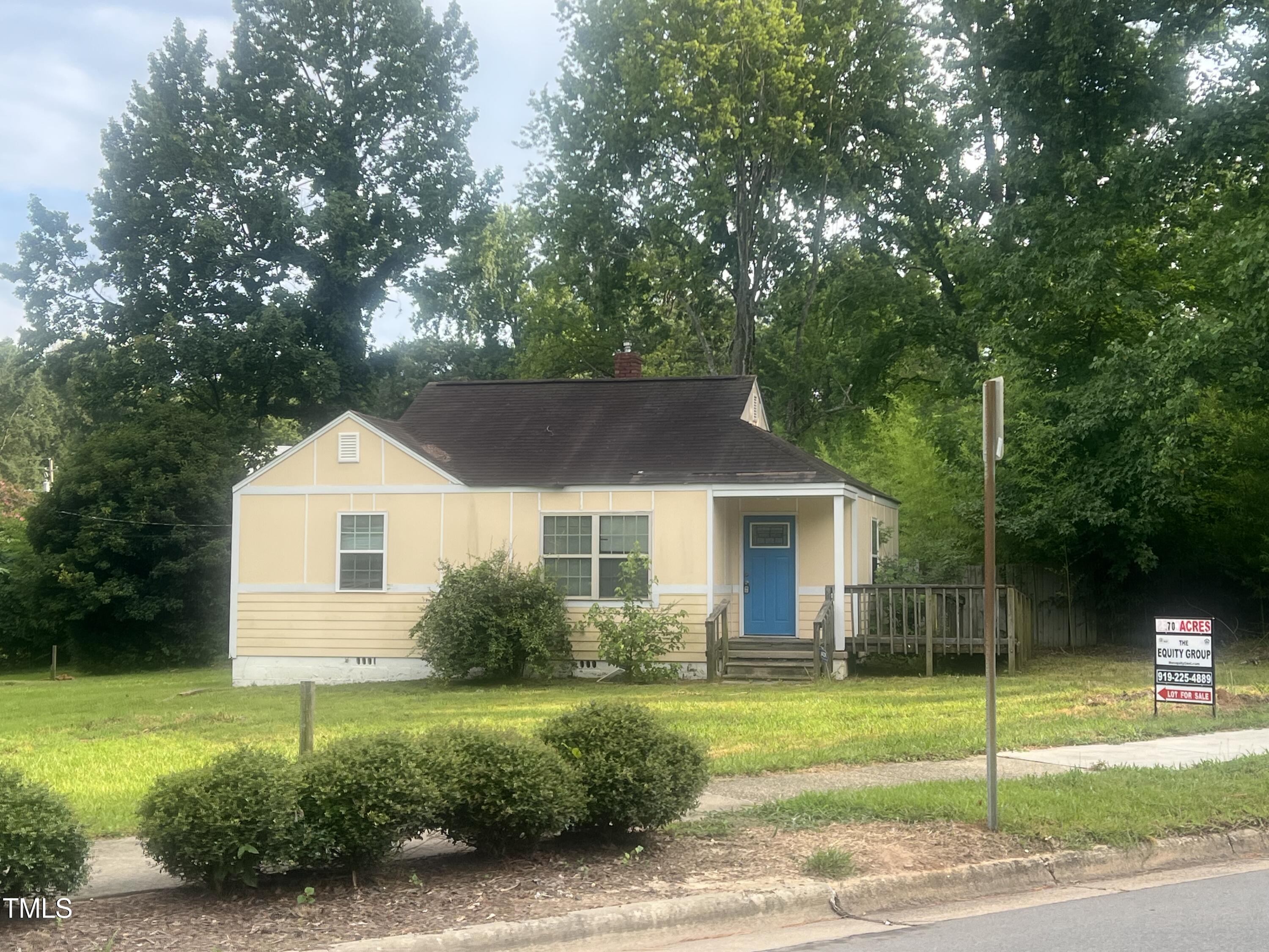 2040 Milburnie Road Raleigh, NC 27610 - Photo 8 of 8 a front view of a house with a garden