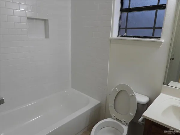 a bathroom with a toilet and a bathtub