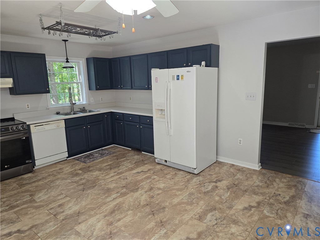 2578 Bagby Road Bumpass, VA 23024 - Photo 10 of 26 Kitchen featuring dark-toned cabinetry, light coun