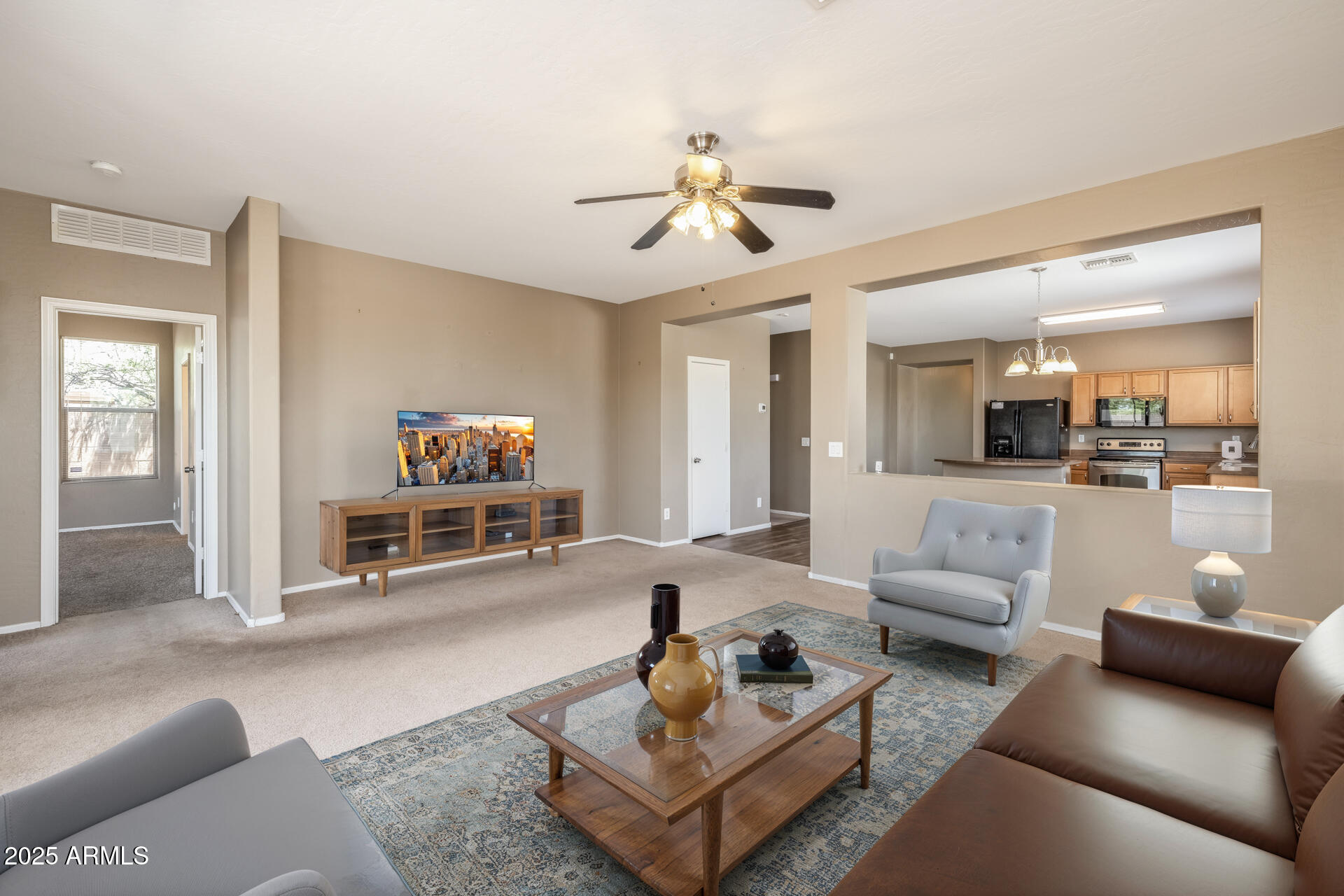 3148 West Maldonado Road Phoenix, AZ 85041 - Photo 13 of 31 a living room with furniture and a flat screen tv