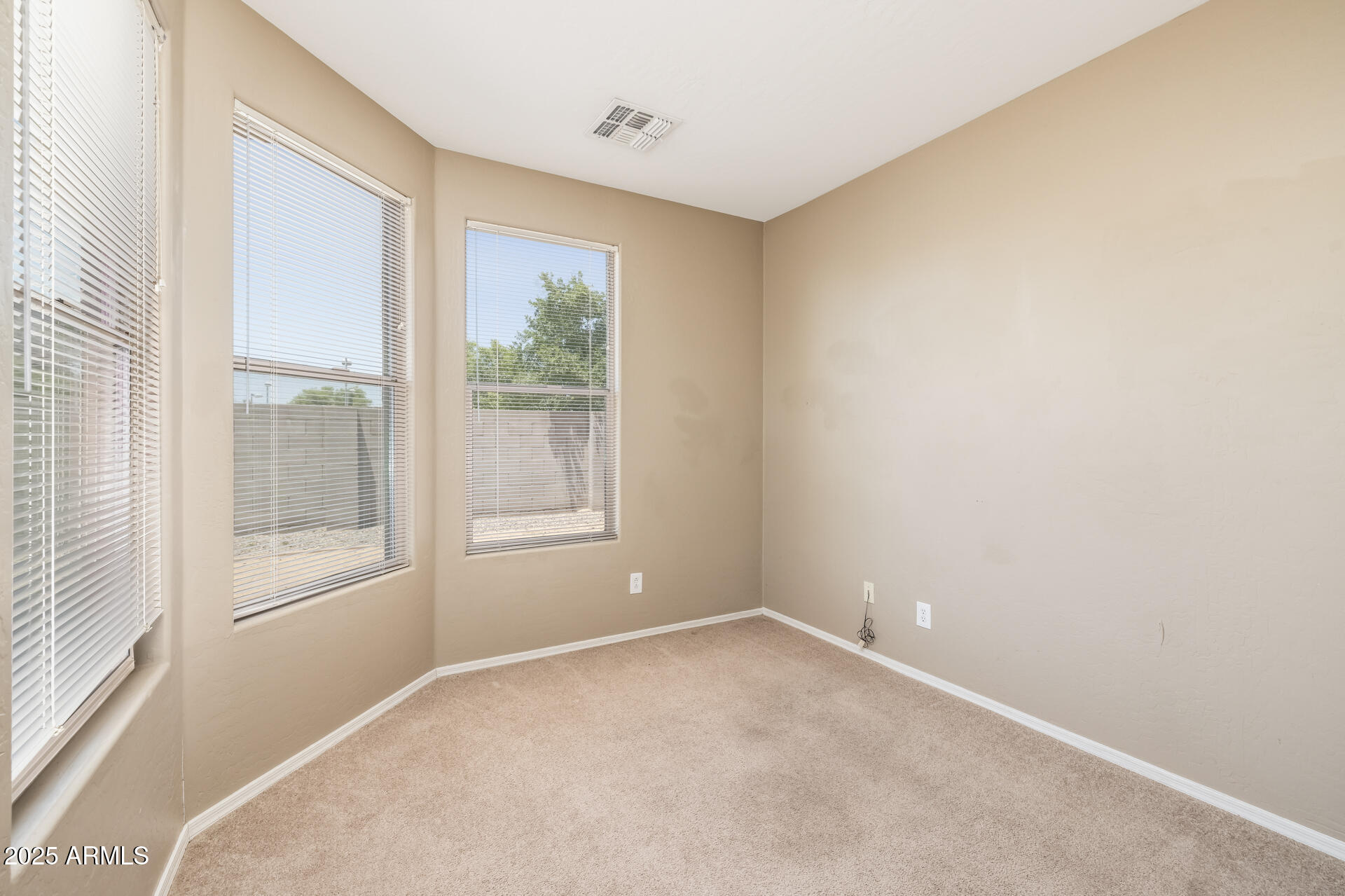 3148 West Maldonado Road Phoenix, AZ 85041 - Photo 16 of 31 a view of an empty room with a window