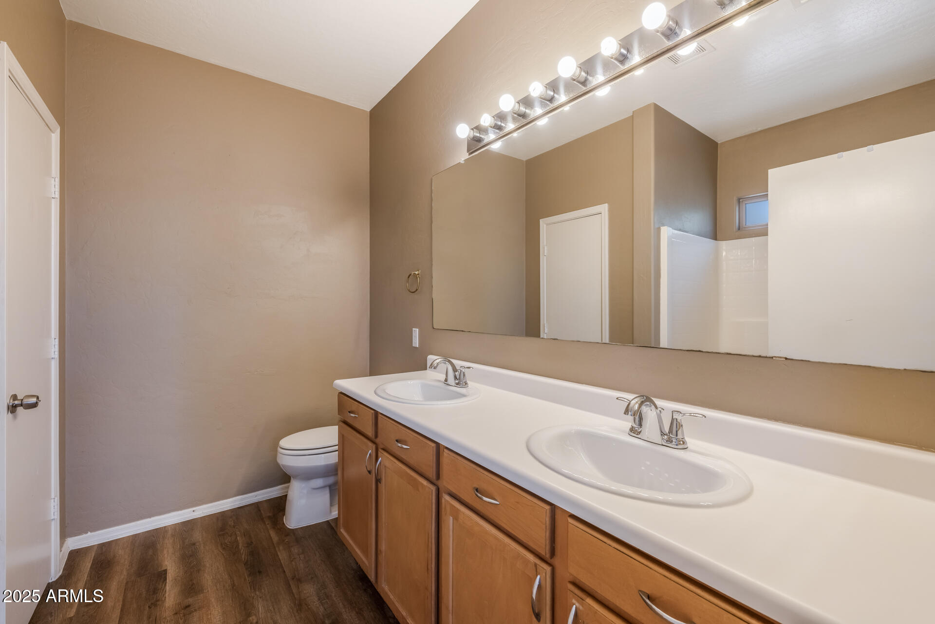 3148 West Maldonado Road Phoenix, AZ 85041 - Photo 20 of 31 a bathroom with a toilet sink and mirror