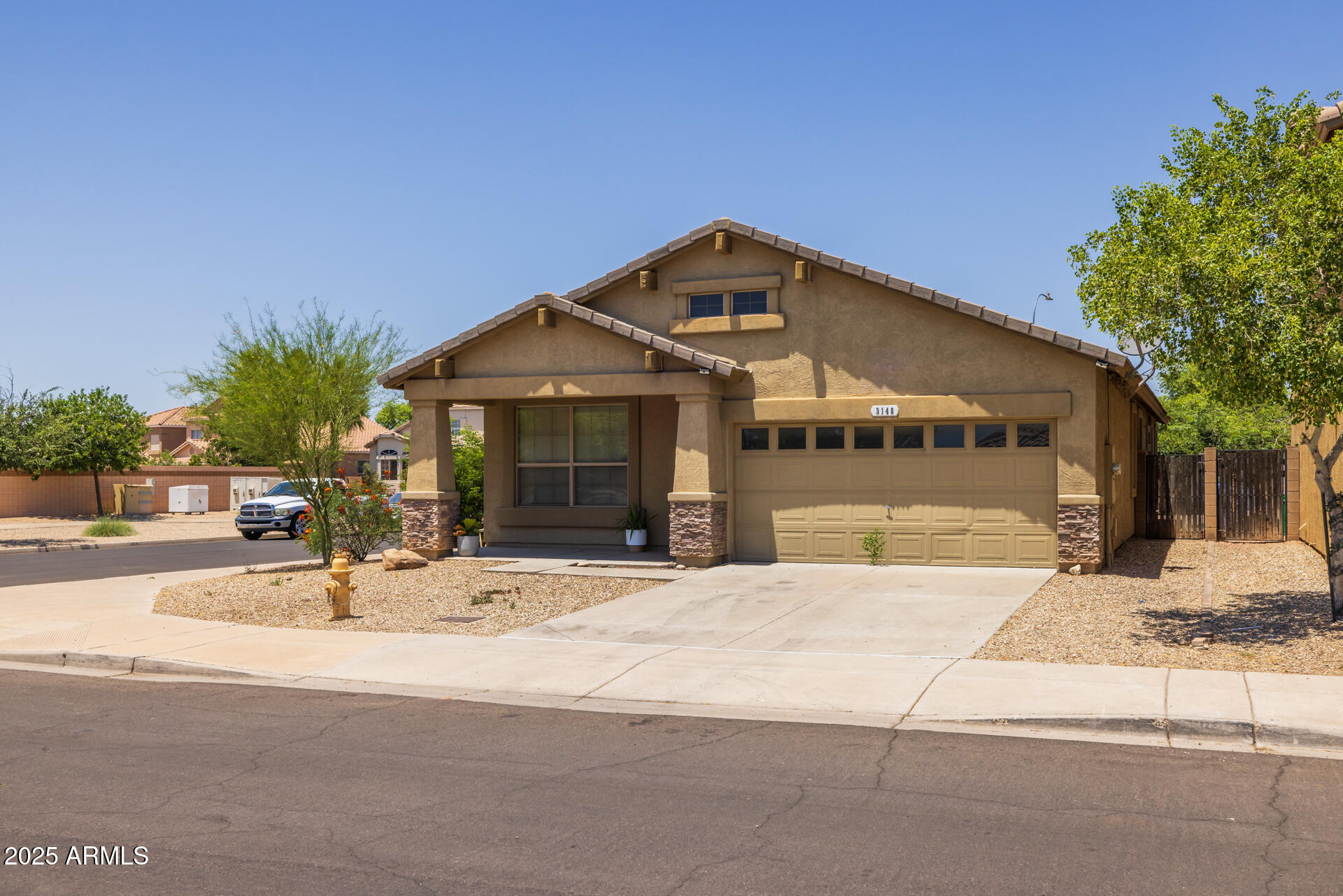 3148 West Maldonado Road Phoenix, AZ 85041 - Photo 2 of 31 a front view of a house with a garden