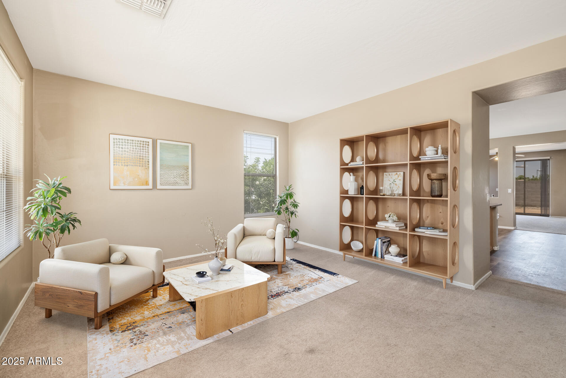 3148 West Maldonado Road Phoenix, AZ 85041 - Photo 4 of 31 a bedroom with furniture and a book shelf