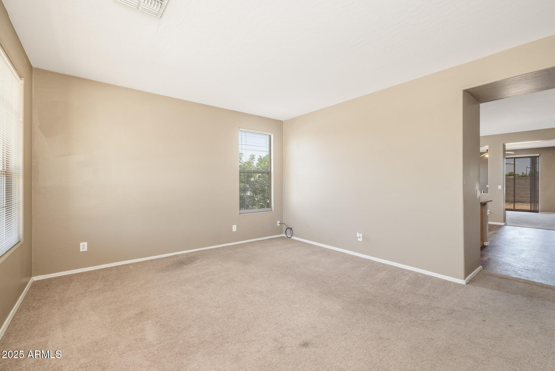3148 West Maldonado Road Phoenix, AZ 85041 - Photo 5 of 31 an empty room with windows and closet