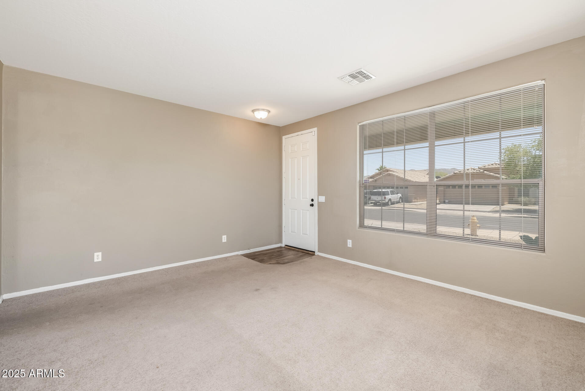 3148 West Maldonado Road Phoenix, AZ 85041 - Photo 6 of 31 a view of an empty room with a window