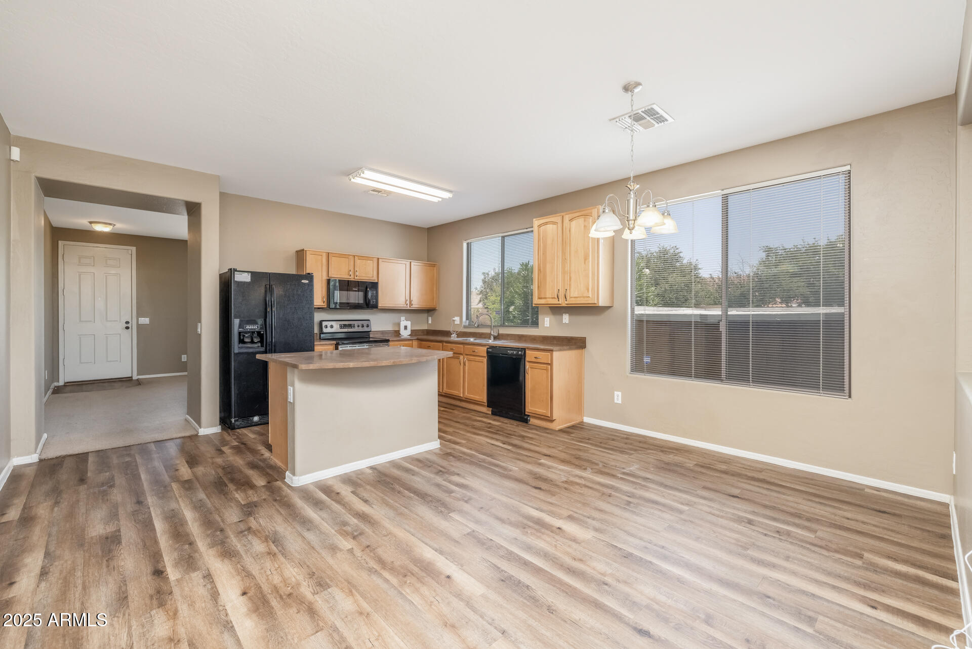 3148 West Maldonado Road Phoenix, AZ 85041 - Photo 7 of 31 a kitchen with stainless steel appliances granite countertop a refrigerator and a stove top oven