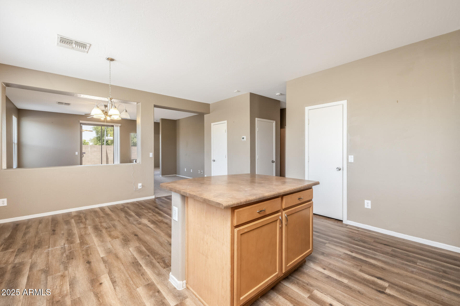 3148 West Maldonado Road Phoenix, AZ 85041 - Photo 9 of 31 a kitchen with a sink and a mirror