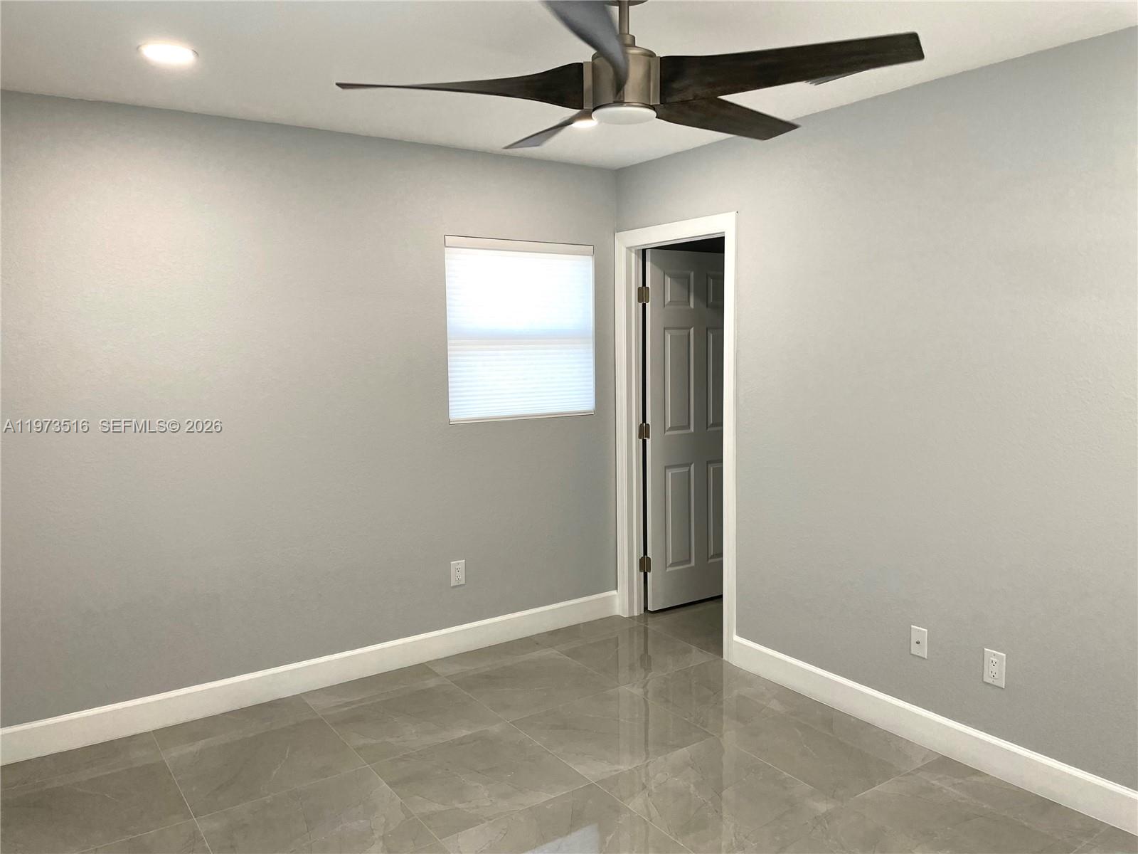 1280 West Camino Real, Unit 1280 Boca Raton, FL 33486 - Photo 11 of 26 an empty room with windows and fan