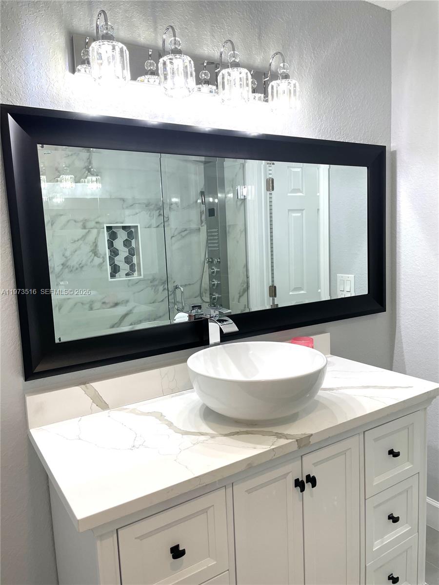 1280 West Camino Real, Unit 1280 Boca Raton, FL 33486 - Photo 16 of 26 a bathroom with a sink and a mirror