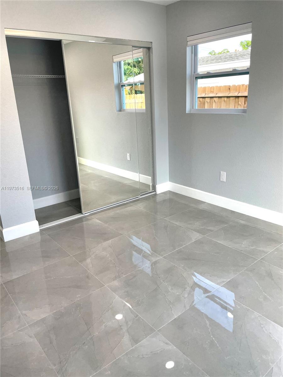 1280 West Camino Real, Unit 1280 Boca Raton, FL 33486 - Photo 18 of 26 an empty room with windows