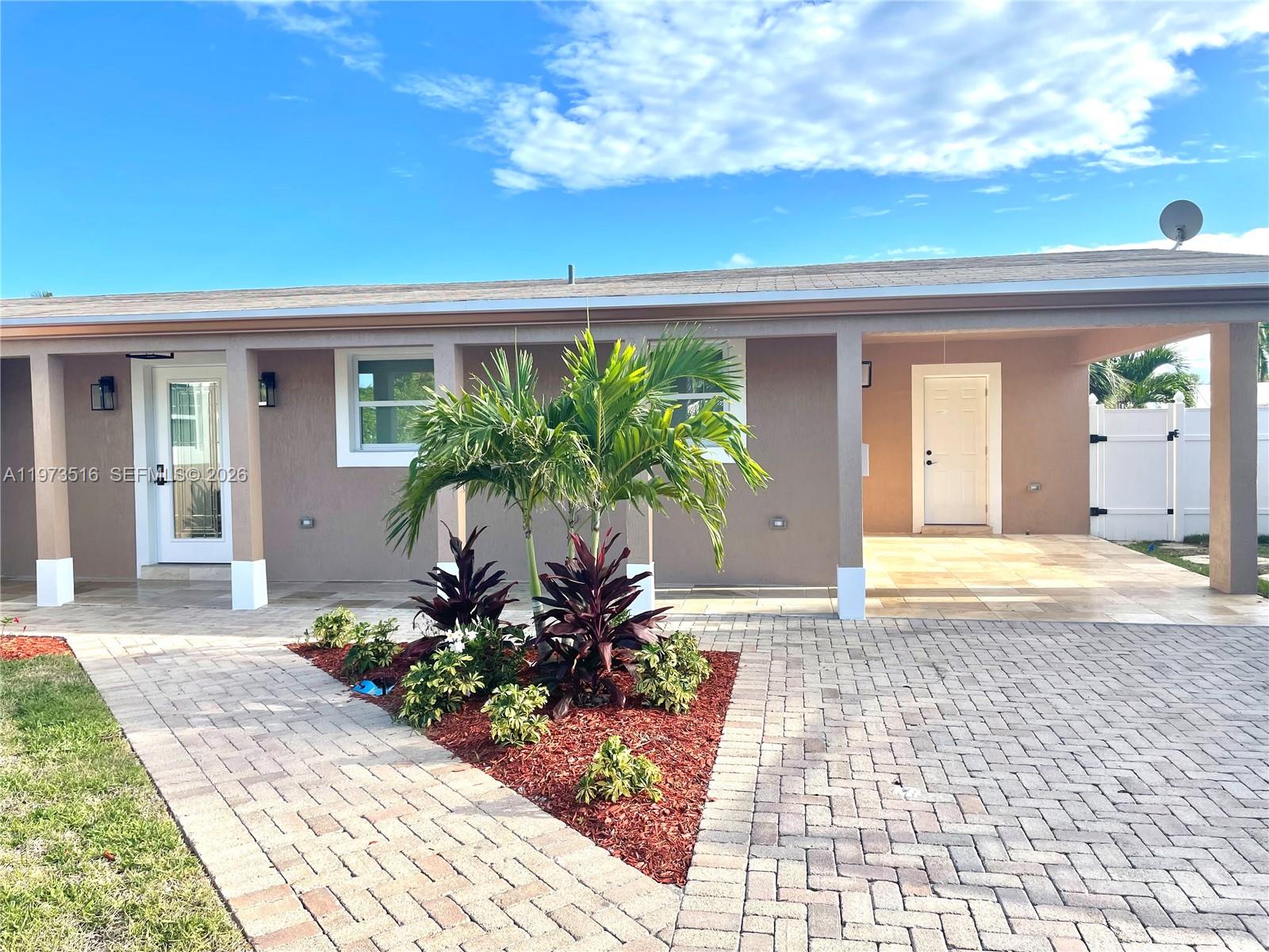 1280 West Camino Real, Unit 1280 Boca Raton, FL 33486 - Photo 23 of 26 a front view of a house with a yard