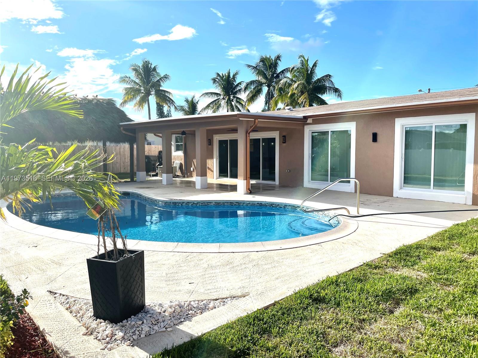 1280 West Camino Real, Unit 1280 Boca Raton, FL 33486 - Photo 24 of 26 a view of a house with pool and chairs