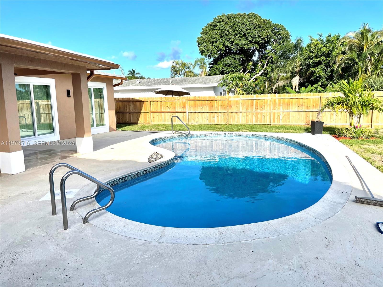 1280 West Camino Real, Unit 1280 Boca Raton, FL 33486 - Photo 25 of 26 a view of a swimming pool with a lounge chair