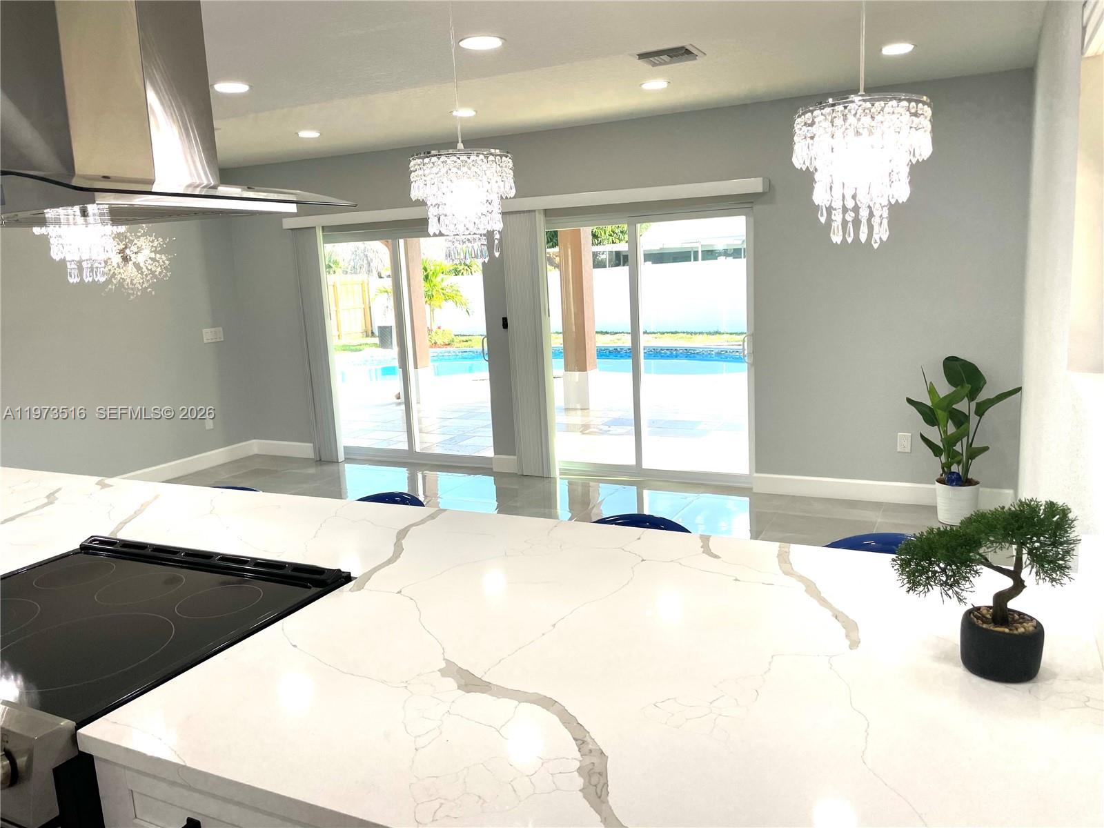 1280 West Camino Real, Unit 1280 Boca Raton, FL 33486 - Photo 7 of 26 a bed room with a bed mirror and a chandelier