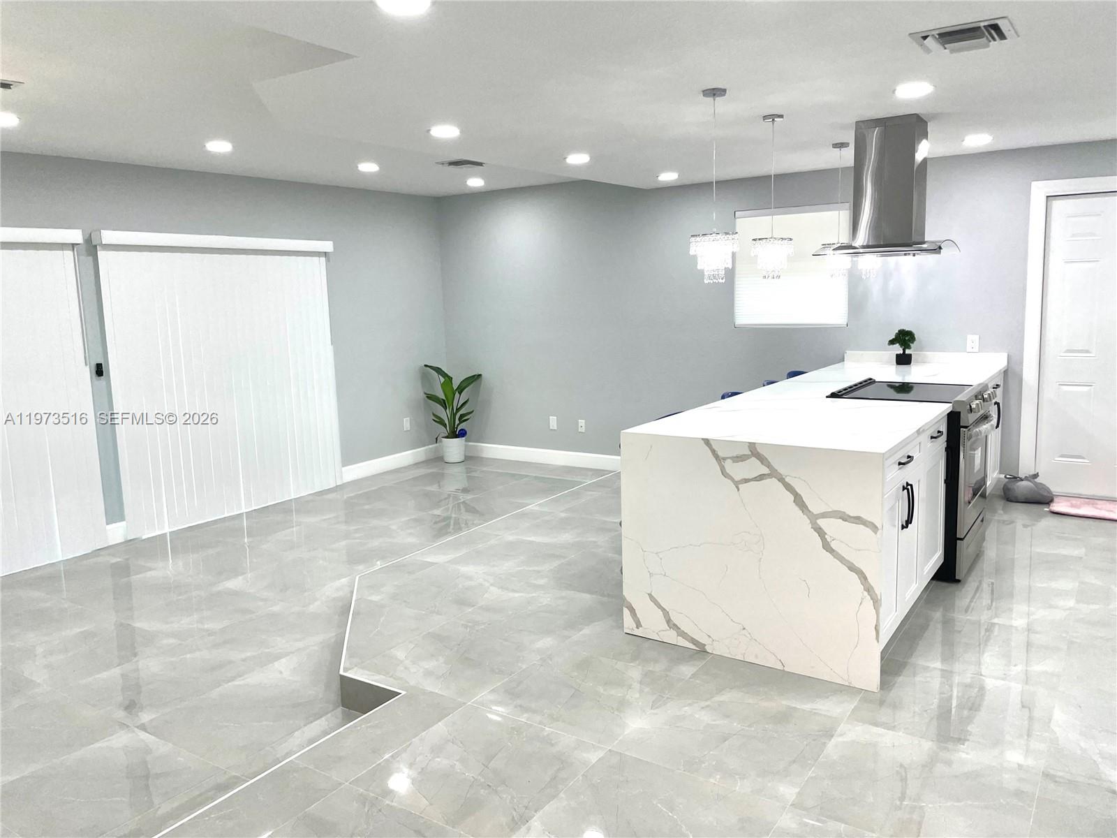 1280 West Camino Real, Unit 1280 Boca Raton, FL 33486 - Photo 8 of 26 a large white kitchen with a large window