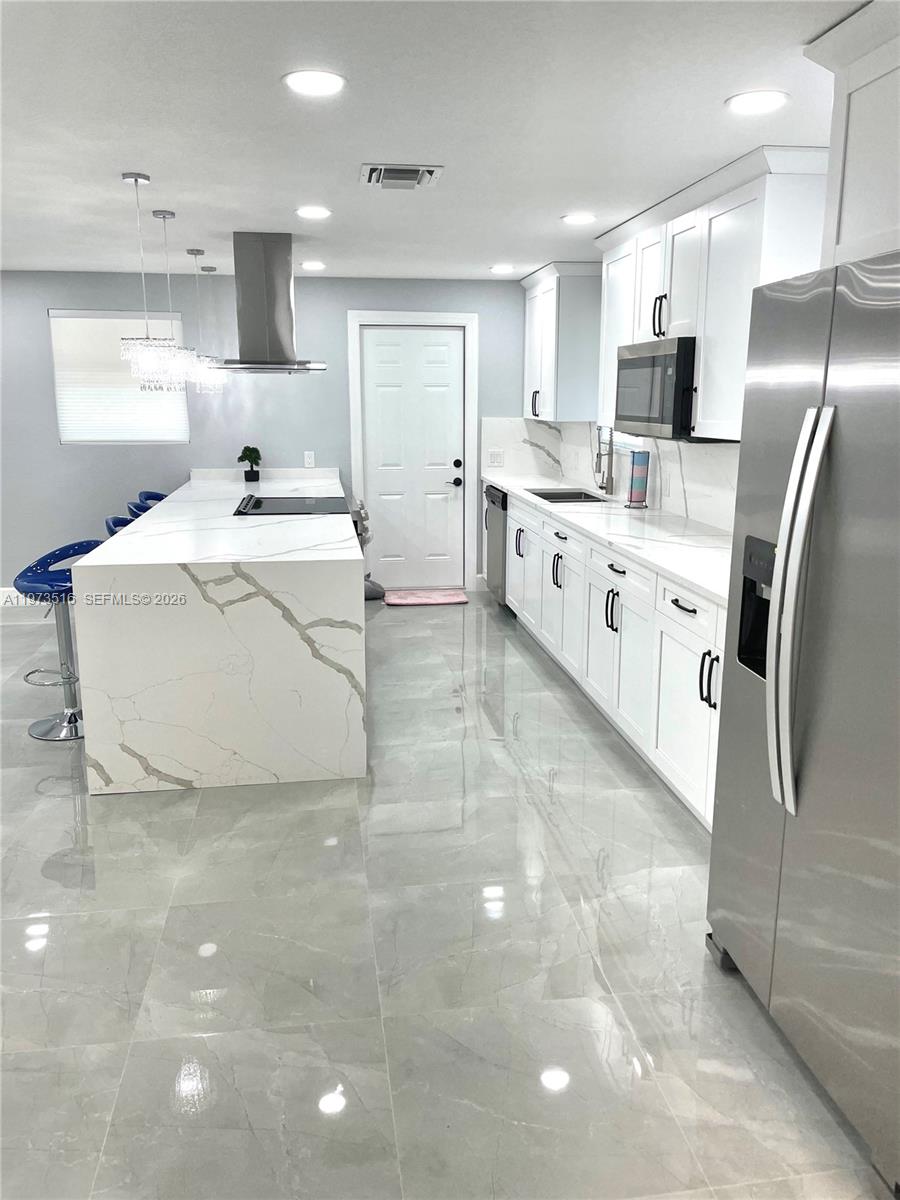 1280 West Camino Real, Unit 1280 Boca Raton, FL 33486 - Photo 9 of 26 a large white kitchen with stainless steel appliances cabinets a sink and a counter top space