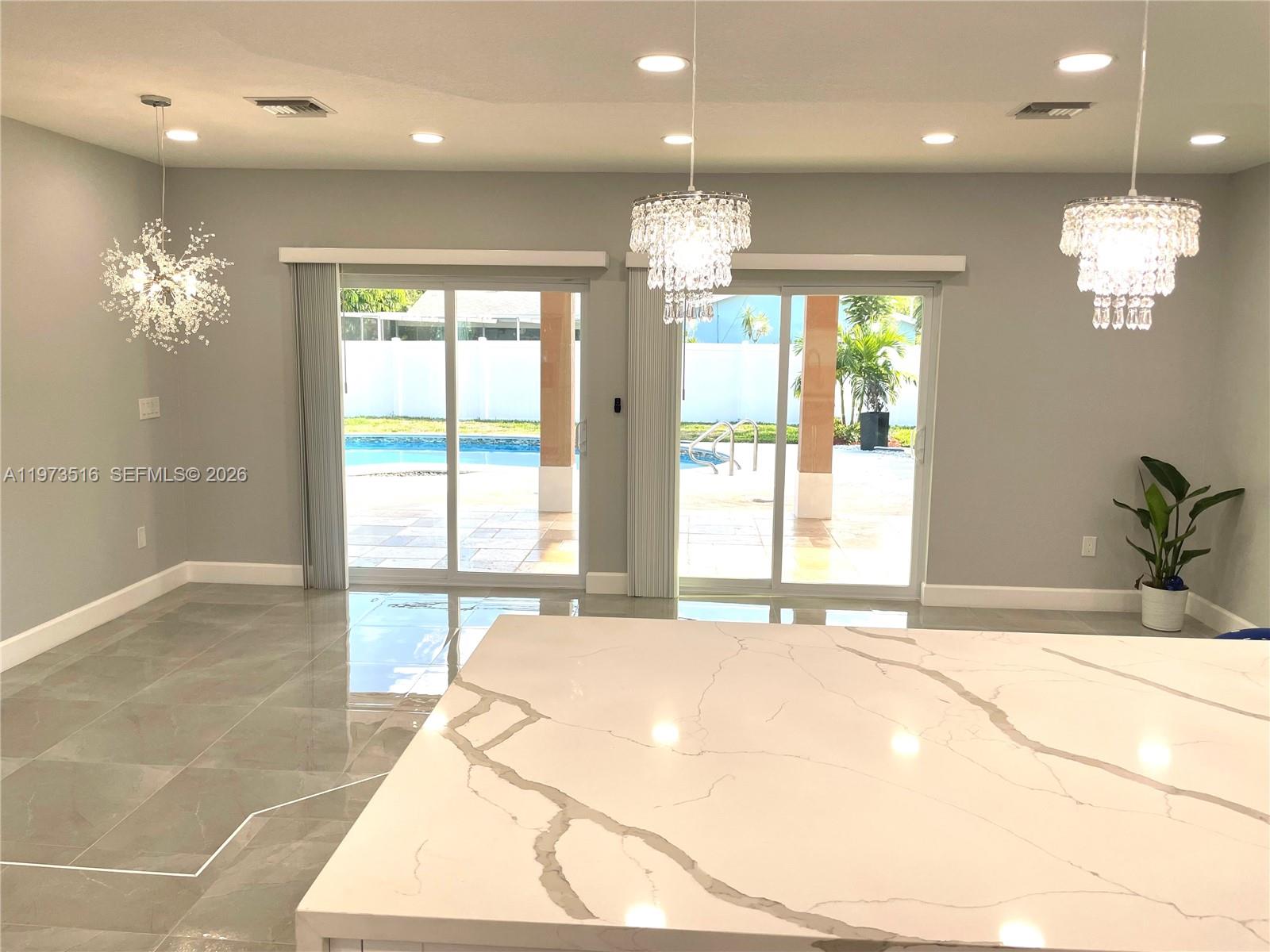 1280 West Camino Real, Unit 1280 Boca Raton, FL 33486 - Photo 10 of 26 a view of an entryway of a room with a chandelier