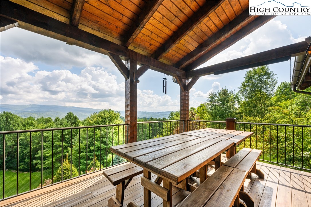 333 Windy Ridge Road Vilas, NC 28692 - Photo 6 of 46 a view of a balcony with wooden floor and outdoor seating