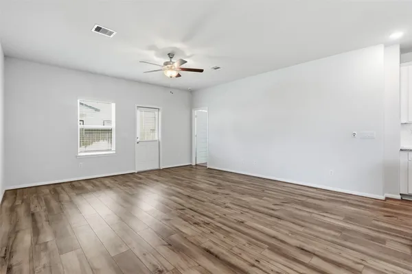 wooden floor in an empty room with a window